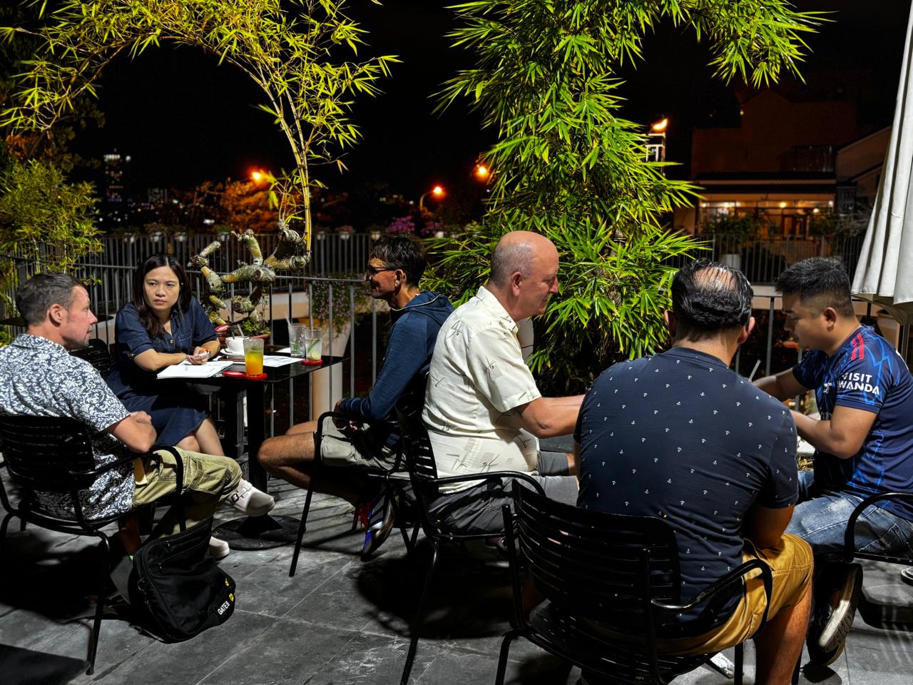A wider view of two active conversation tables during the Friday, April 24, 2026 Da Nang Language Exchange session.